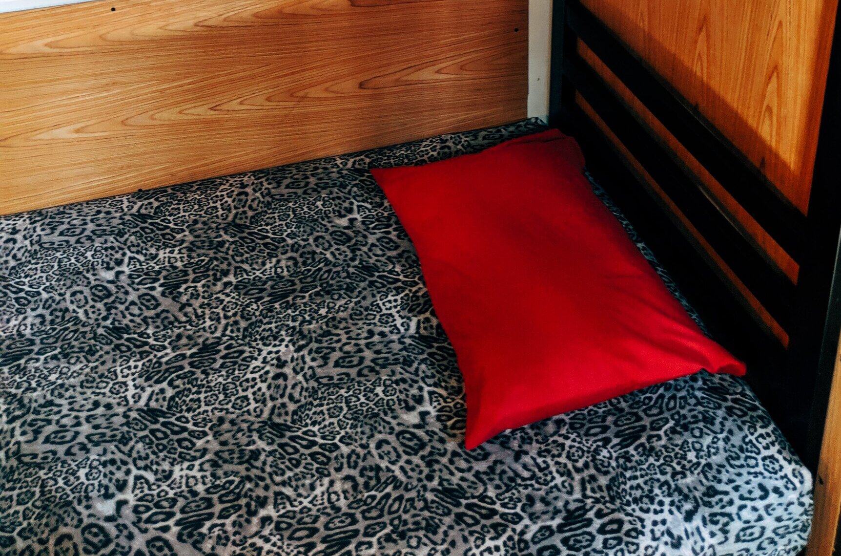 bunkbed with a red pillow