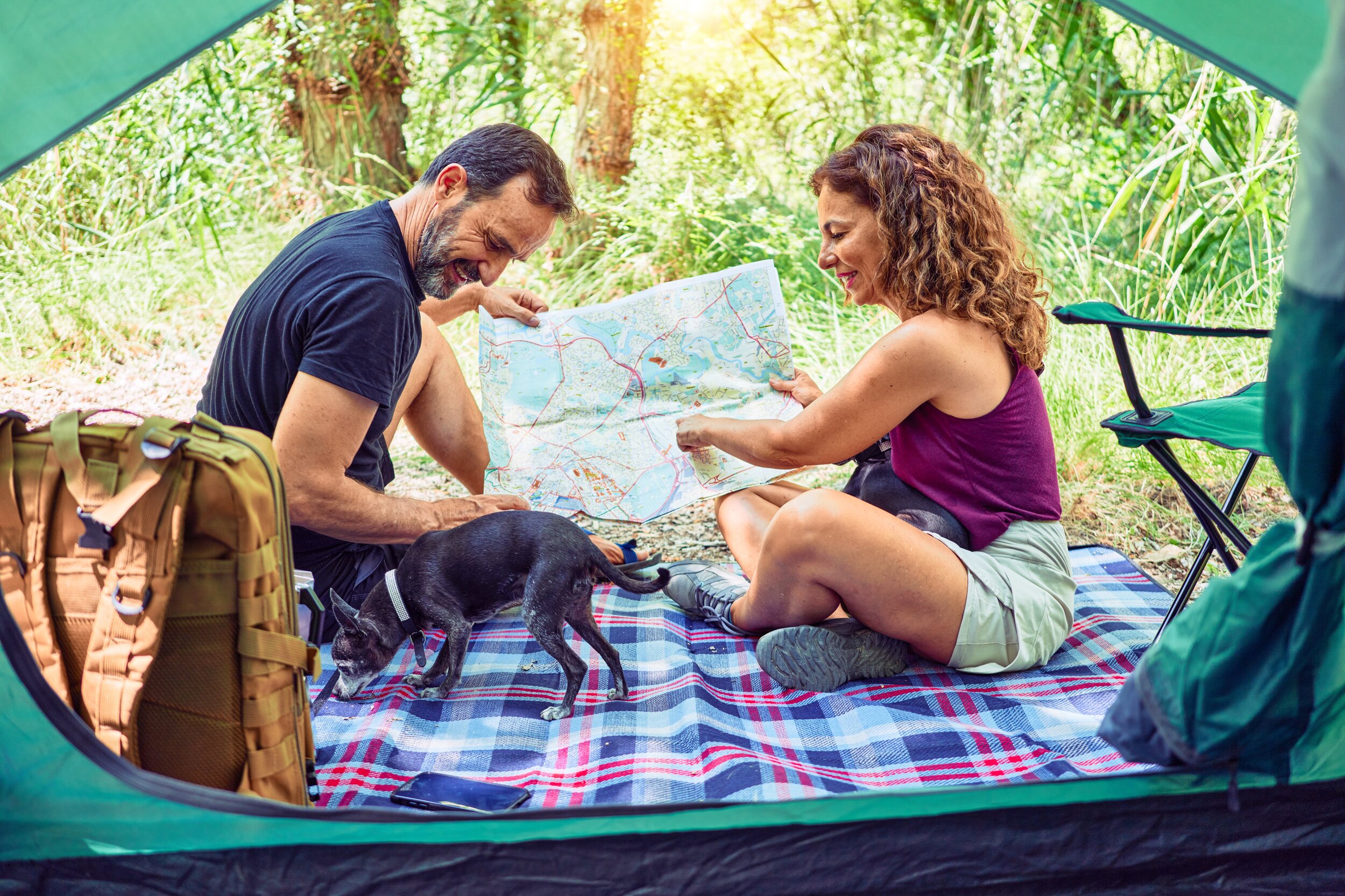 man and woman with dog and map